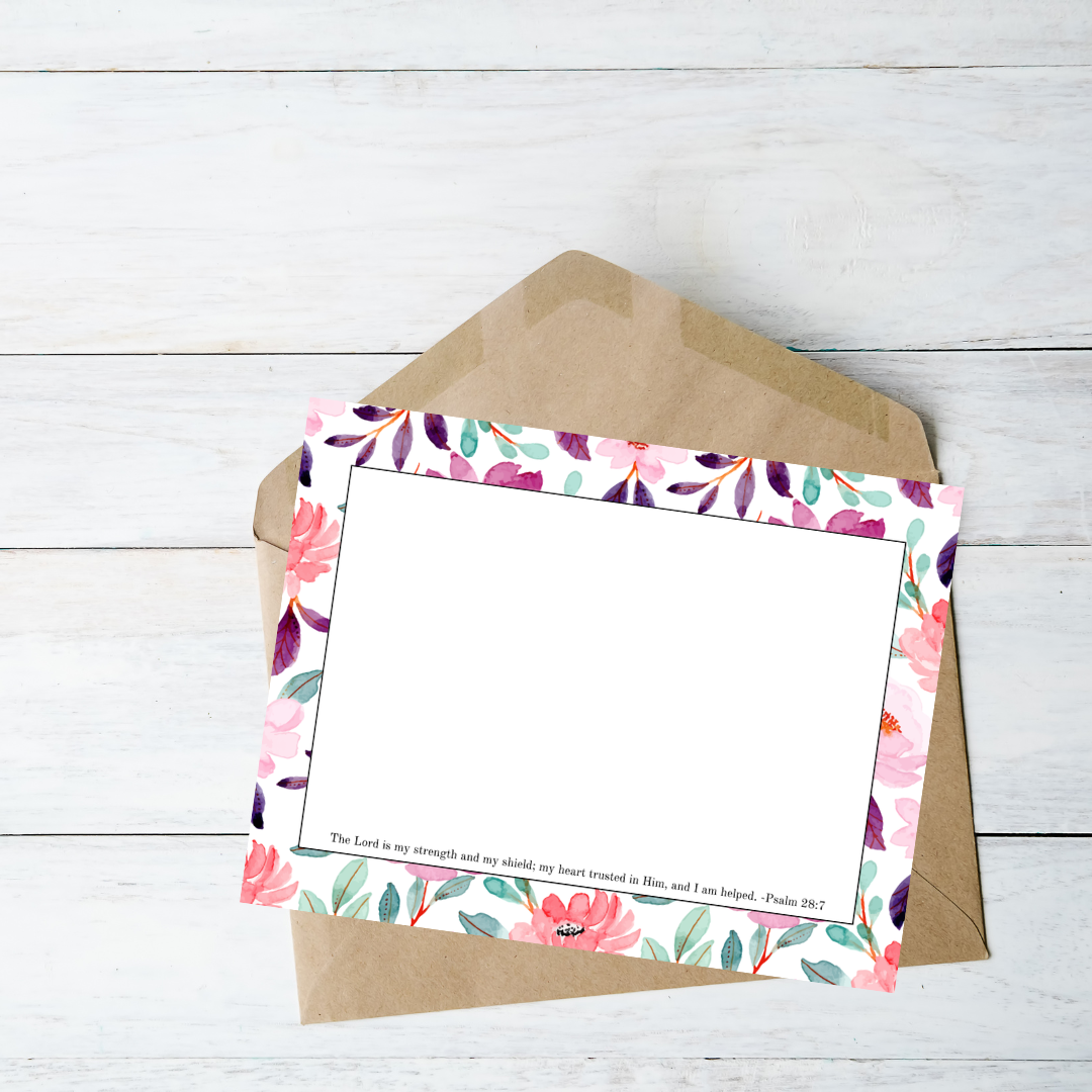 Floral letterhead with a brown envelope on a light wooden surface