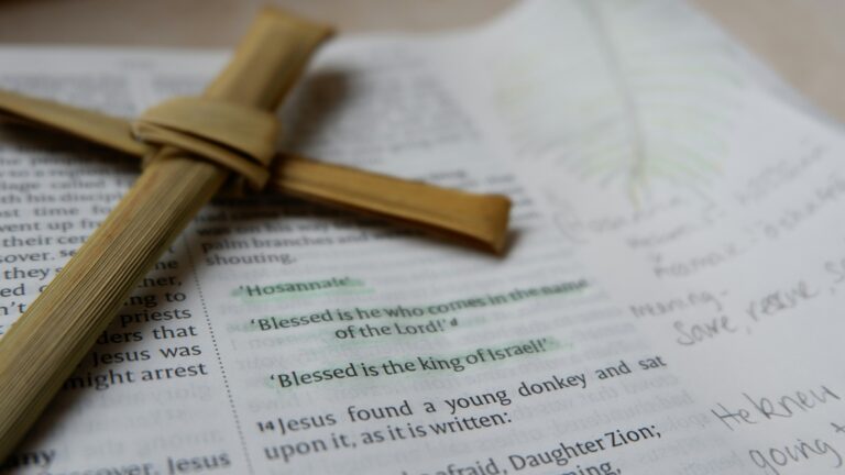 open bible and cross on white background
